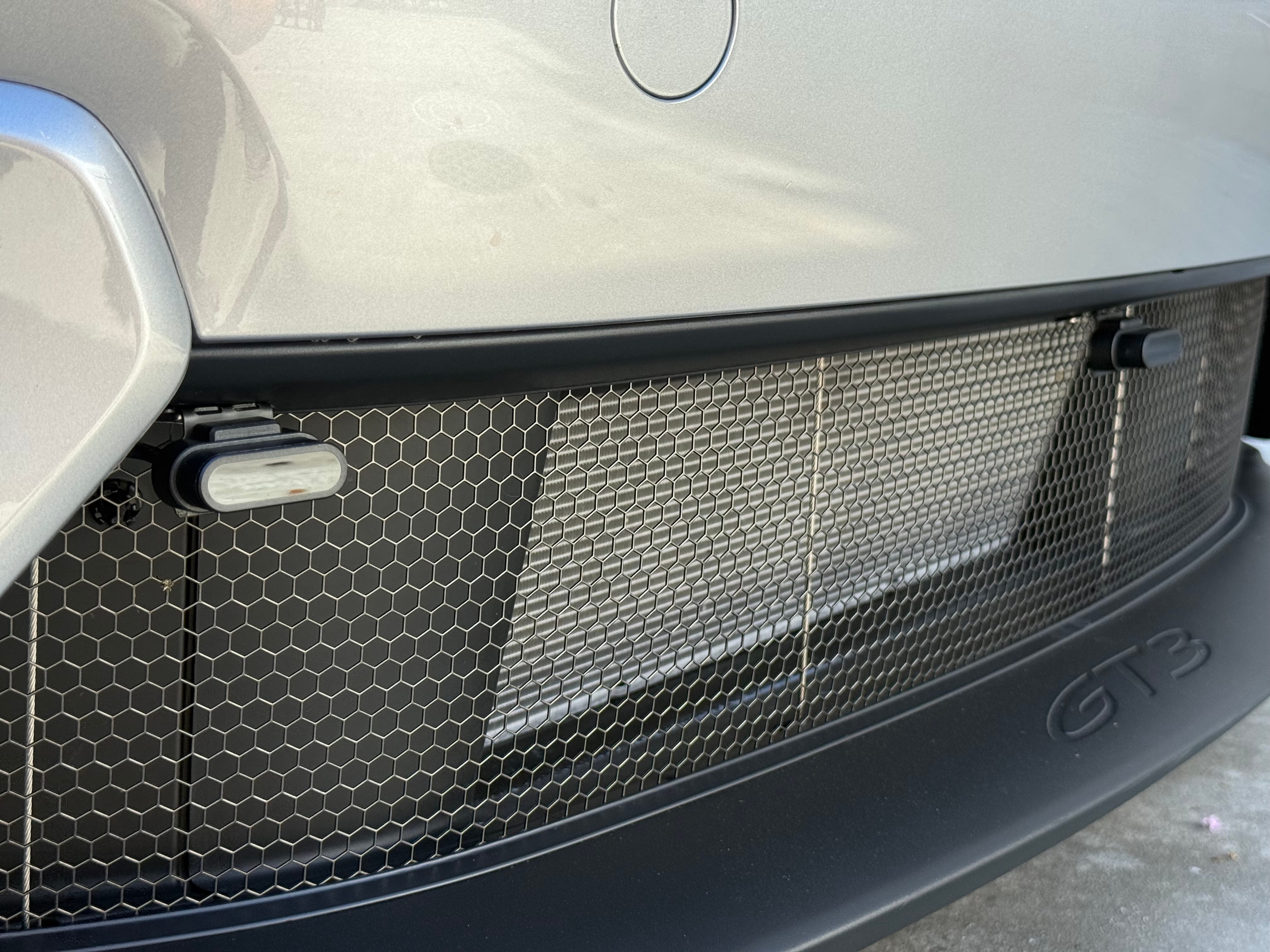 Porsche GT3 grille close-up showing ZR6 laser shifter heads mounted in mesh