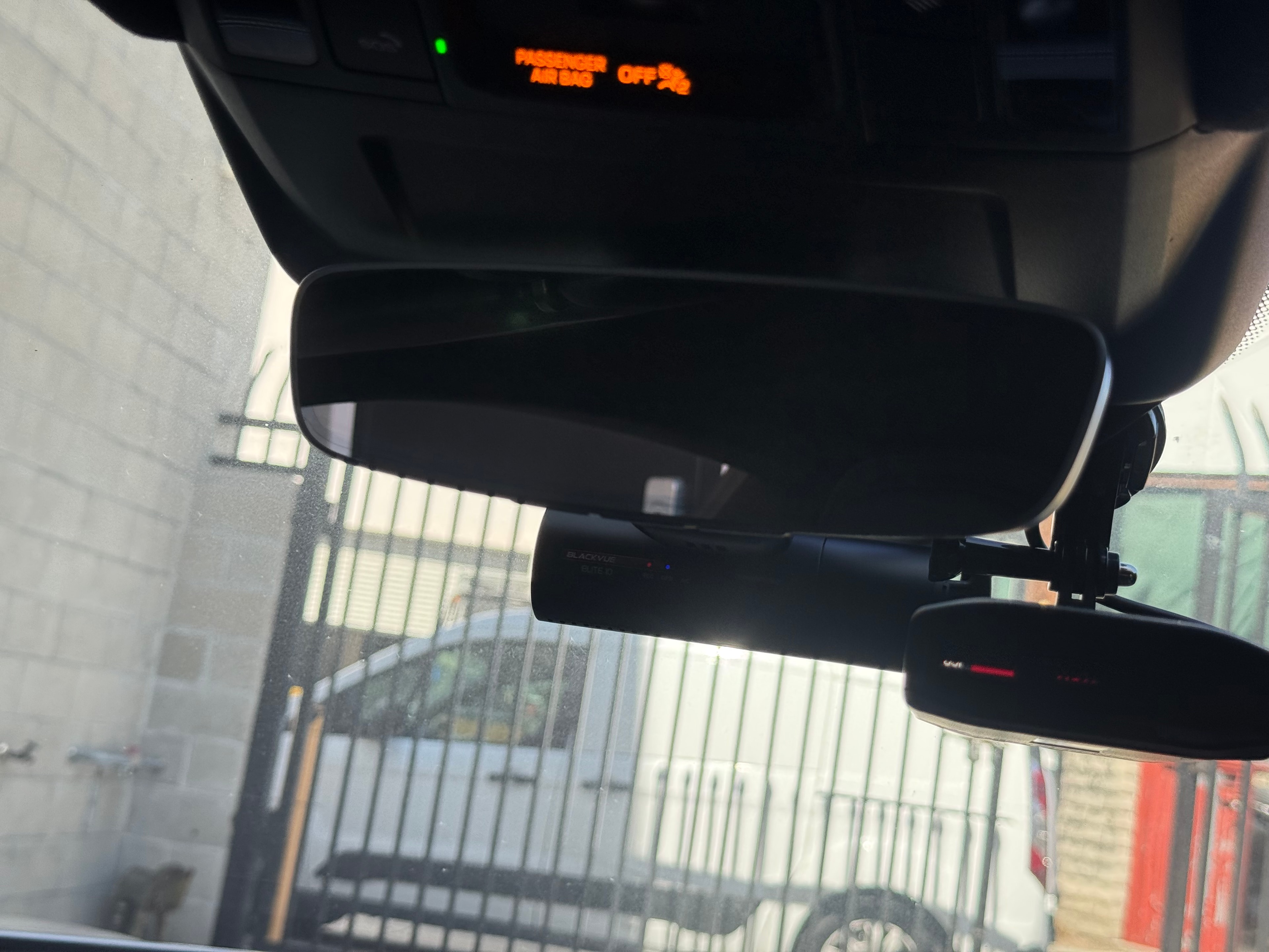 Professional radar detector and dashcam installation — interior view